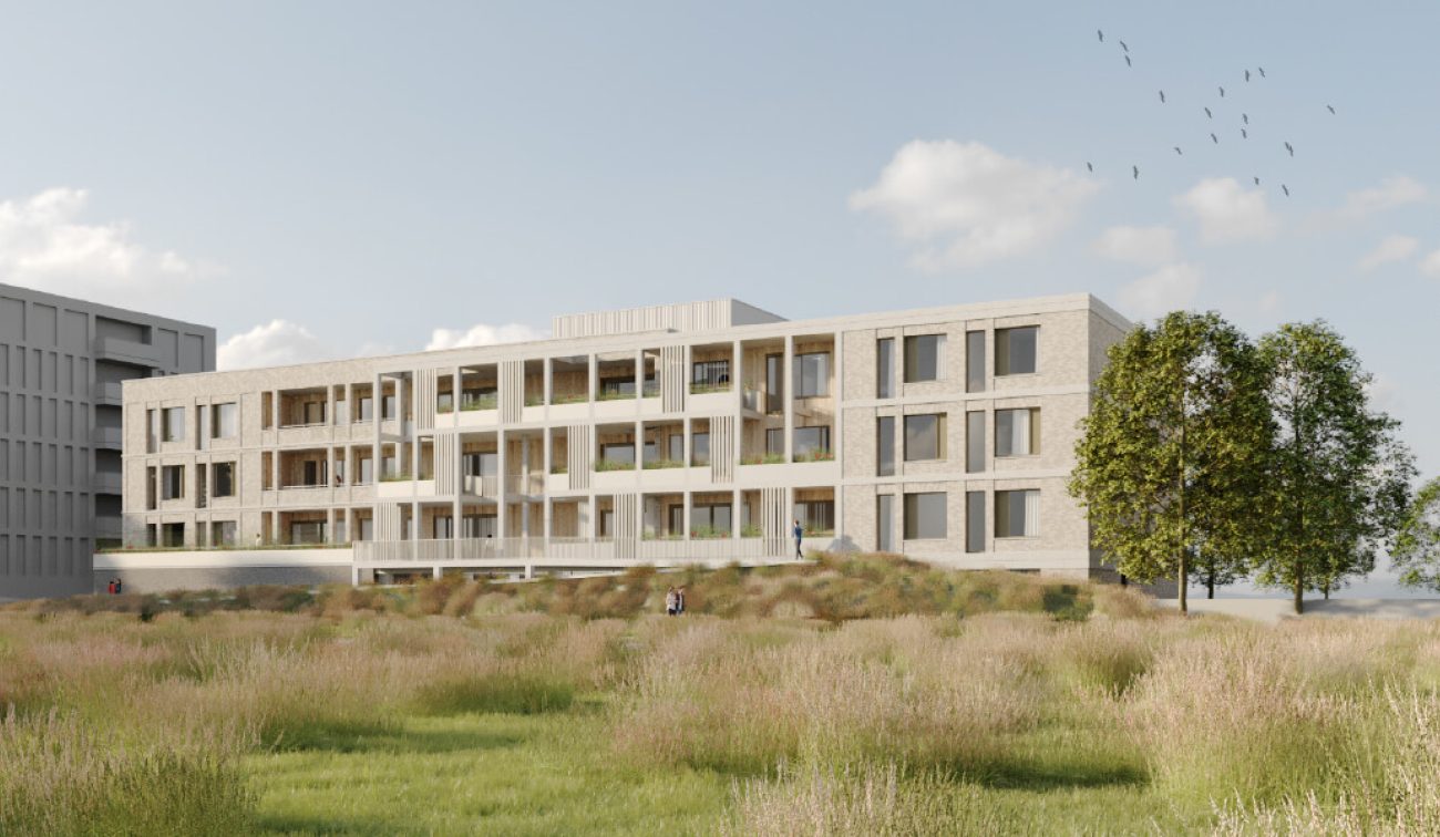 De Baron Bergen op Zoom: licht bakstenen woongebouw met witte kaders, balkons, bomen, grasveld open.