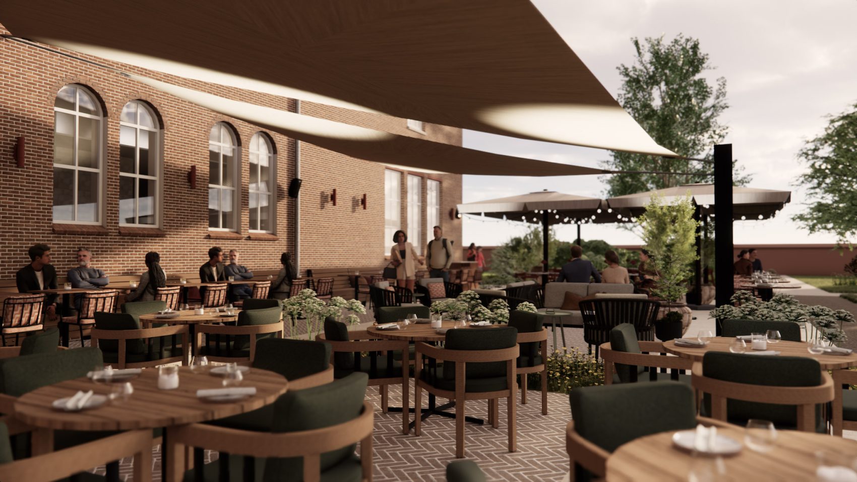 Impressie Hotel Clara Eindhoven – terras met schaduwdoeken, bakstenen gevel, groen en sfeerverlichting