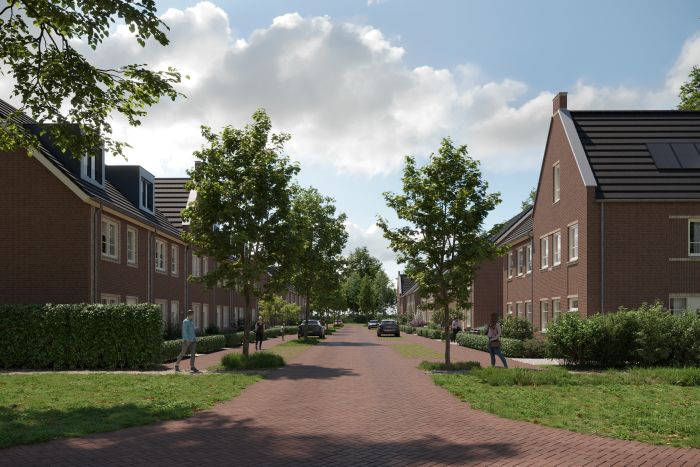 Groene woonstraat in Bosrijk Mariendaal, Velp met bakstenen rijwoningen aan beide zijden, jonge bomen, rood klinkerwegdek, wandelaars en geparkeerde auto’s.