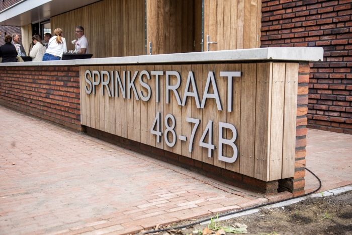 Houten entree-element met adres Sprinkstraat 48–74B, nieuwbouw sociale huur Margraten.