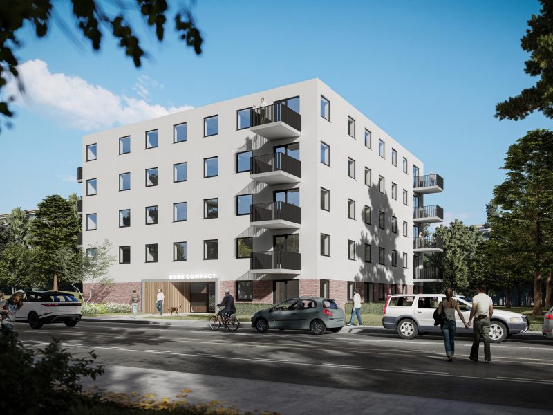 Impressie nieuwbouw Noorderkroon Brunssum – modern vijflaags appartementengebouw met witte gevel, straatzijde met uitkragende balkons, bomen en passerend verkeer