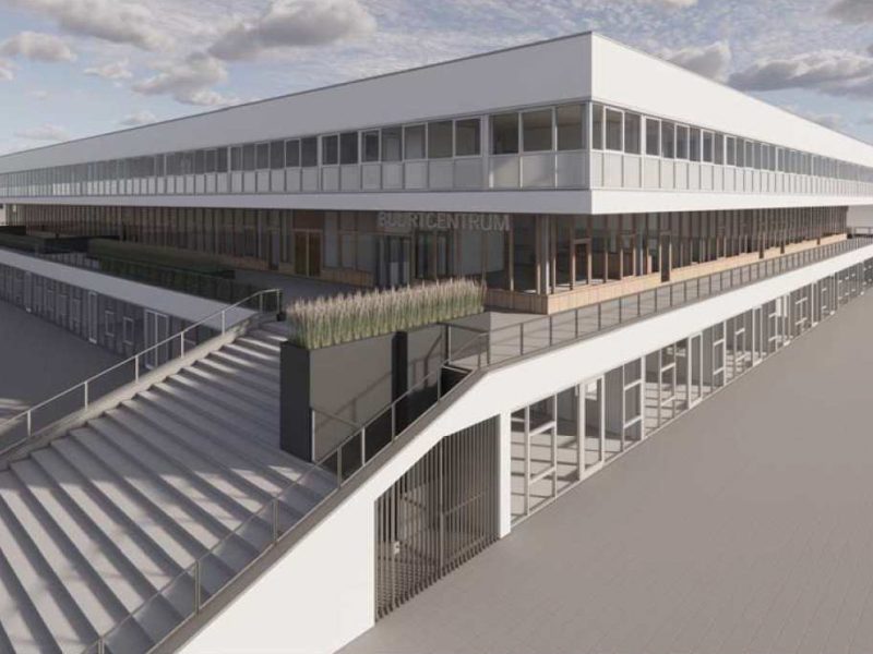 Bedrijfsgebouw met langgerekte glazen gevel, meerdere verdiepingen en verhoogd terras