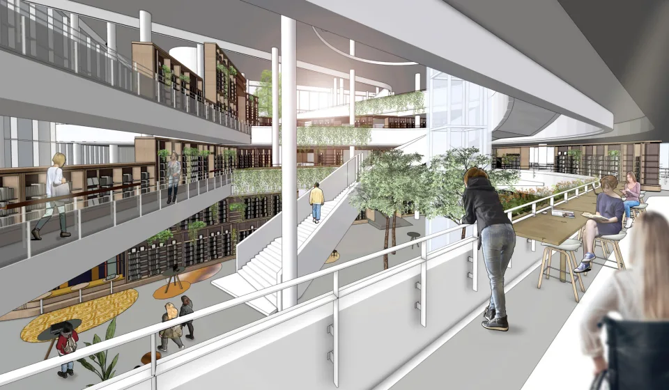 Interieurimpressie van open gebouw met meerdere verdiepingen, trappen, boekenkasten en groene beplanting